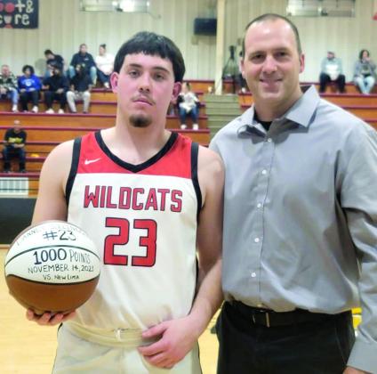 Earlsboro senior Danney Billingsley poses with Coach Chad Rochelle and the game ball after joining the 1,000-Point Club at New Lima on Nov. 14. Photo provided