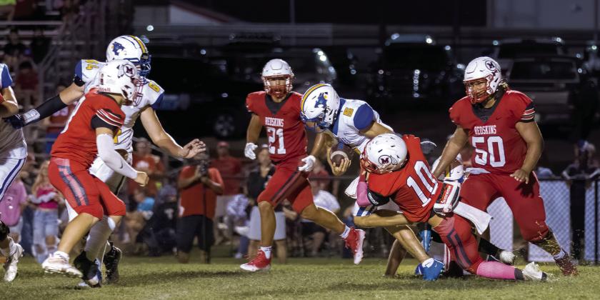 Bethel sophomore Bryce Tapley runs the ball as McLoud senior Ben Greenberg tries to take him down during the game at McLoud on Sept. 9. McLoud won 21-7. Photo provided by Richelle Treece.