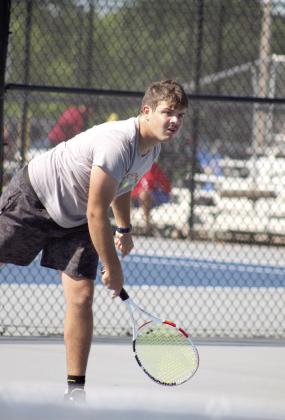 Noah Henson, on the Tecumseh #1 Doubles team with Ted Belshe, watches the ball after making his stroke during the Shawnee NGB (National Governing Body) Tournament on May 3. They were playing Shawnee. Natasha Dunagan, Countywide &amp;amp; Sun