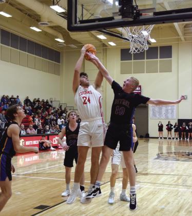 North Rock Creek’s Jace Plumb takes a shot while Bethel’s Austin Brown tries to block.