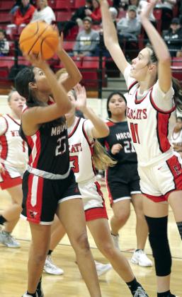 Macomb sophomore McKenzie Brummett aims for the basket, as Earlsboro junior Natalie Peters (#11) plays defense, in the Earlsboro home game on Dec. 12. The Lady Wildcats won, 40-37, and the Wildcats also beat the Hornets, 78-32, that night.