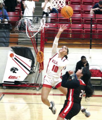 After stealing the ball, Earlsboro freshman Mia Tanyan makes two points, as Macomb sophomore Yasmine Vance runs up on defense, on Dec. 12.