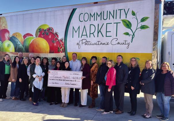 Board Members &amp;amp; Staff from Community Market and Avedis Foundation together with Daniel Matthews, Executive Director CMPC (center, white shirt) and Kathy Laster, Ph. D., MBA President &amp;amp; CEO Avedis Foundation (on Matthews left, holding the end of the check). Photo provided