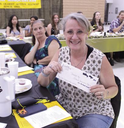 Julie Shankle of Redondo Beach, CA, received a gift card from Gilbert Insurance Agency for traveling the farthest to the 124th Annual Tecumseh Alumni Banquet, held at the WP Wood THS Alumni Center on May 30.