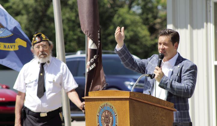 American Legion Post 260 Adjutant Bill Gammage looks on as State Senator Shane Jett speaks during the Memorial Day service at Tecumseh Cemetery on May 27. Rev. Paul Fletcher, with Northridge Church of Christ in Shawnee also spoke, as well as Gammage. Countywide &amp; Sun/Natasha Dunagan