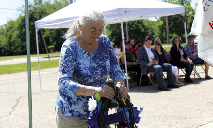 American Legion Post 260 Auxiliary Member Carolyn Rose places a wreath for the Emergency Responders during the Memorial Day service at Tecumseh Cemetery on May 27. Wreaths were also placed for each military branch, and an 18-gun salute was given. Rev. Paul Fletcher, with Northridge Church of Christ in Shawnee, and State Senator Shane Jett spoke, as well as Post Adjutant Bill Gammage. Countywide &amp; Sun/Natasha Dunagan
