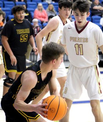Tecumseh’s Brady Overstreet looks to pass around a Byng defender during the First United Bank Classic consolation championship round in Bethel on Dec. 11.