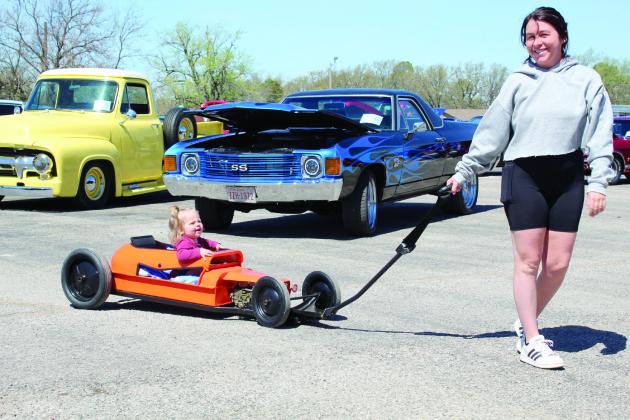 One-and-a-half-year-old Luna Putlak rides in a “slammed roadster Smith, during the car show. wagon” pulled by Taryn Putlak and built by her grandfather, Vince Flores, during the 7th Annual Bethel Band Boosters Car Show on April 8. Countywide &amp;amp; Sun/Natasha Dunagan