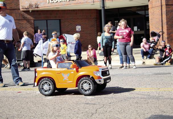 A little girl, with Cowboys Plumbing, waves from her battery-operated truck during the Frontier Days Parade on Sept. 25, 2021. Cowboys Plumbing also had a horse and buggy and a cowboy mascot in the parade. Countywide &amp;amp; Sun/Natasha Dunagan
