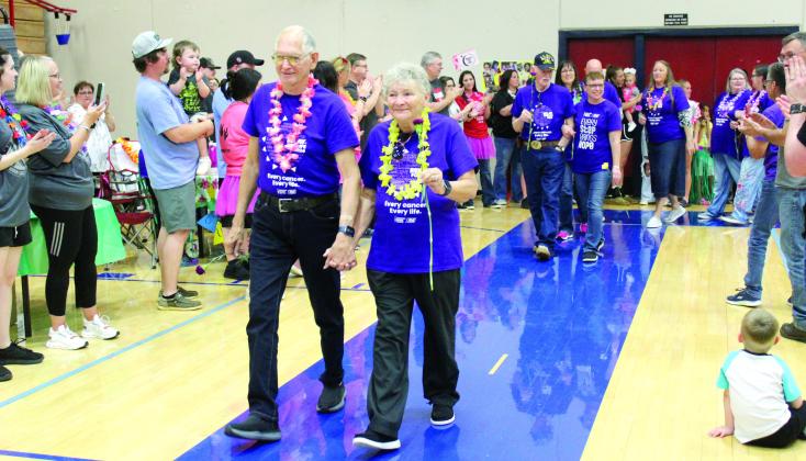 Kenneth and Linda Weston, of Shawnee, walk in the cancer survivors’ first lap of the Relay for Life, as they and others are applauded, on April 26. Countywide &amp;amp; Sun/Natasha Dunagan