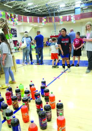 Ella Gee, 9, of Shawnee, tosses a ring at the SSM Health booth during Relay for Life on April 26.