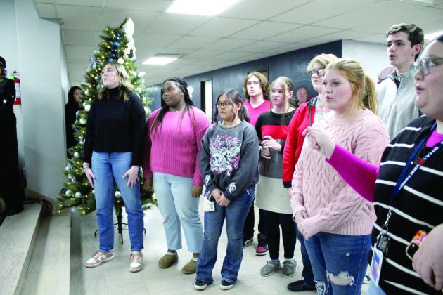 The Shawnee High School Jazz Choir sings “Happy Birthday” to Band Director Christopher Hall before the Dec. 2 Board of Education meeting. Countywide &amp; Sun/Natasha Dunagan