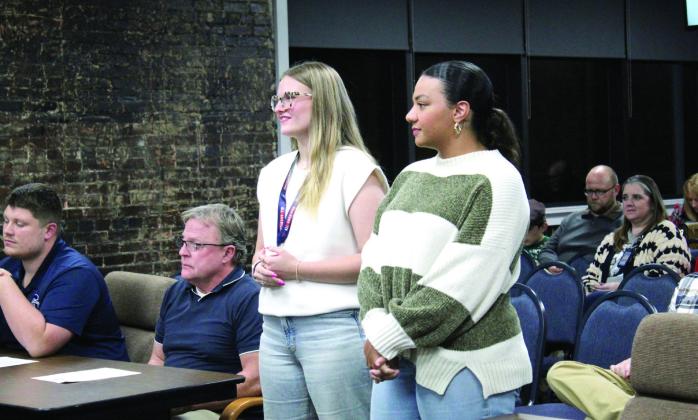 Shawnee junior Addison Harris and Pom Team Coach Lydia Johnson are introduced by Interim Superintendent Dr. Teresa Wilkerson during the Dec. 2 Shawnee Board of Education meeting. Harris was recently chosen for the National Dance Alliance All-American Team. Countywide &amp; Sun/Natasha Dunagan