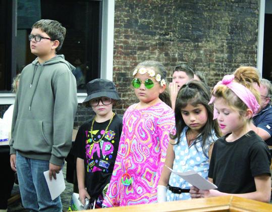 Will Rogers Elementary students read facts about each decade from the 1950s to 2000s to celebrate Will Roger’s birthday, which was on Nov. 4, 1879. They had originally planned to present “Will Rogers Through the Decades” at the November Board of Education meeting, but had to postpone until the Dec. 2 meeting due to weather. Shown, from left, are Alex Sehaume, Decker White, Amelia Sehaume, Prestynn Neely and Peyton Neely. Countywide &amp; Sun/Natasha Dunagan