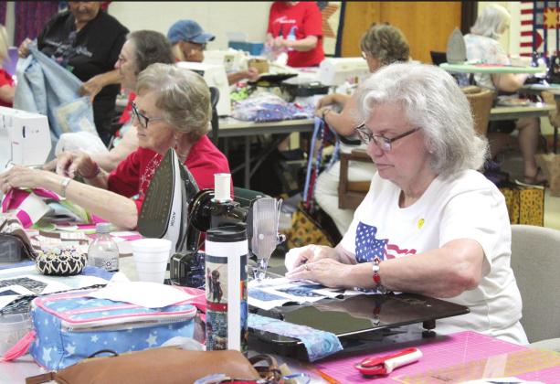Spinning Spools Quilt Guild charter member Ann Cosgrove, right, and Harriett Howard, left, work on quilt squares during the Quilt Camp on June 25. Countywide &amp;amp; Sun/Natasha Dunagan