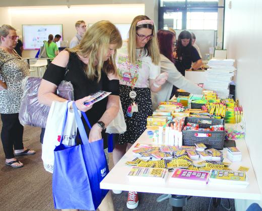 Horace Mann Elementary third-grade teacher Janet Hopper, Will Rogers Elementary fourth-grade teacher Shelby Cowden, and Shawnee Middle School eighth-grade math teacher Stephanie Bayne select school supplies during the Second Annual Pack the School Teacher Supply Stop, held at First United Bank's Harrison branch in Shawnee on Aug. 1. Hopper has been a teacher for 29 years and said she spends over $200 on supplies each year.