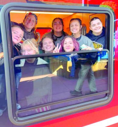 Tecumseh High School band students smile from the window of the Pikes Peak Cog Railway which took them to the top of Pikes Peak to see the view and the “America the Beautiful” monument. Photo provided.