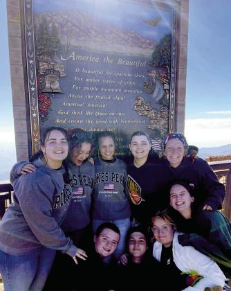 Some of the 61 Tecumseh High School band students pose in front of the “America the Beautiful” monument on top of Pikes Peak over Labor Day weekend. They later performed at the America the Beautiful Park. Photo provided.