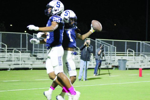 Shawnee junior Ejion Thomas and senior Quentin Trapp celebrate Thomas’s touchdown.