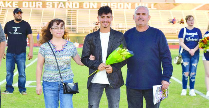 Shawnee Cross Country athlete Steven Avitia is escorted by his mother Miriam Martinez and his dad Carlos Avitia. While in high school, Steven has been in Cross Country, Track, and basketball. After graduation, Steven plans to go to college to pursue a sports business degree. Photo provided by Cherity Pennington.