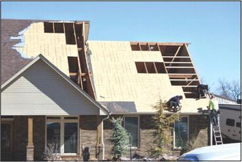 Roof repair is already in progress Monday, Feb. 27, after an EF2 tornado tore through the Snider Heights addition in north Pottawatomie County. Countywide &amp;amp; Sun/Suzie Campbell