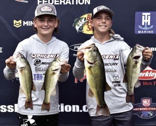 Madden McKiddy and Maddox Dickson pose with the four Largemouth Bass they caught on the second day of the TBF Junior World Championship, July 28. All four totalled 11 pounds, 7 ounces, and the biggest fish was 5 pounds, 3 ounces. Their biggest catch also earned them the Daily Big Bass award and was the heaviest for the tournament. Photo provided.