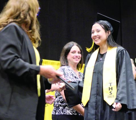 Tessie Hausam smiles at Board Member Iva Bingham before receiving her diploma. Natasha Dunagan, Countywide &amp;amp; Sun