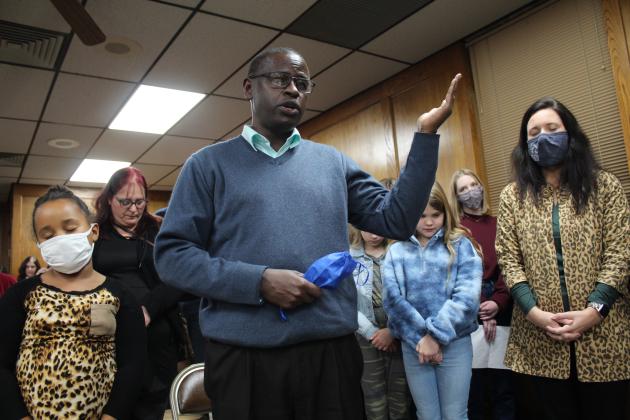 Pastor Gerard Nsabimana, of Wesley United Methodist Church, leads the invocation at the Shawnee Board of Education meeting Jan. 10.
