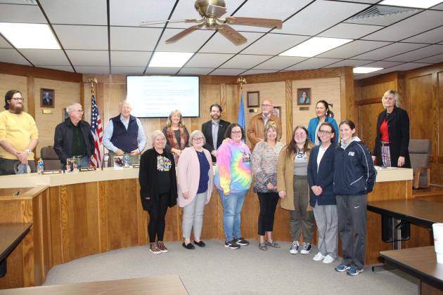 The Shawnee Board of Education members stand behind the Teachers of the Year for each building.