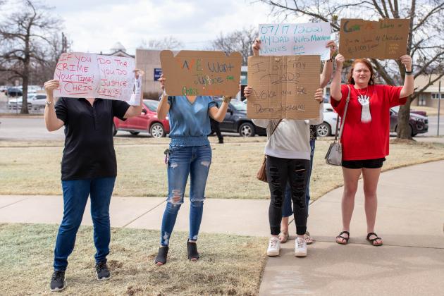 Protesters show their opposition to DA Alan Grubb and corruption.