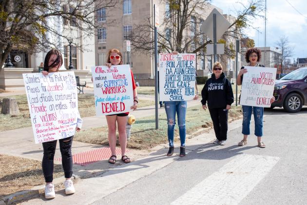 Protesters show their opposition to DA Alan Grubb and corruption.
