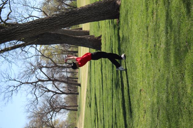 Eli Whitehead, of North Rock Creek, tries to drive through the trees during the Tecumseh Boys Golf Tournament, held at FireLake Golf Course on April 14.