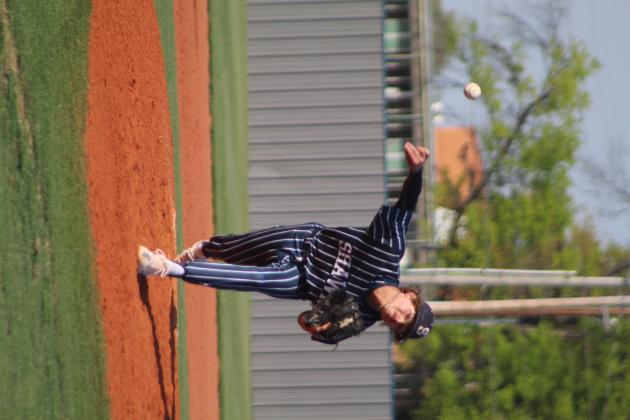 Shawnee senior Kasen Rogers launches the ball toward home plate in the third inning of the home game against Bishop Kelley on April 18. The Shawnee Wolves won, 2-1. Countywide &amp; Sun/Natasha Dunagan