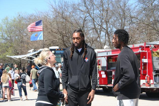 Pott. Co. Commissioner Melissa Dennis talks with two Potawatomi Fire players.