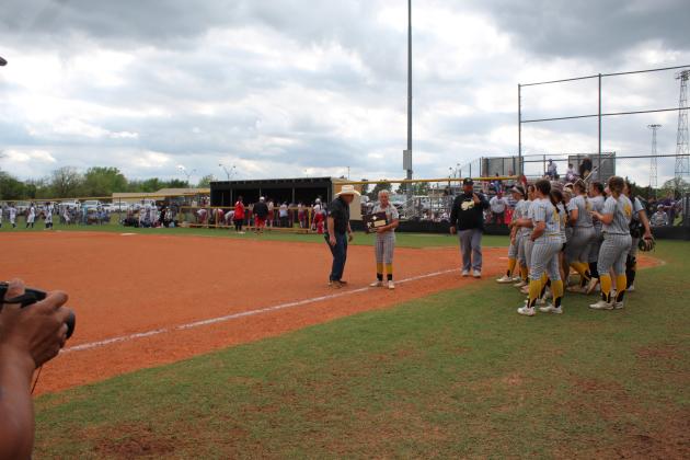 Principal Randy Dilbeck presents the Regional Championship trophy to the Lady Savages.