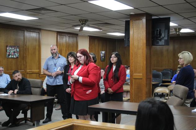 FCCLA member Sierra Frailey speaks to the Board of Education, along with Meagan James and Kali Wind.