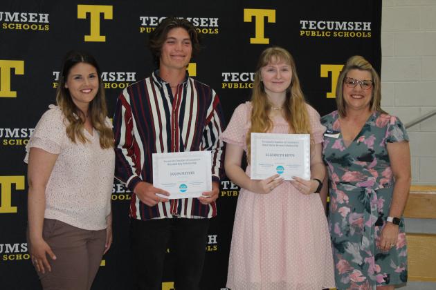 Tecumseh Chamber of Commerce representatives, Katie McMahan, left, and Kellie Clay, far right, presents scholarships to Jaxon Meyers and Elizabeth Kipps.