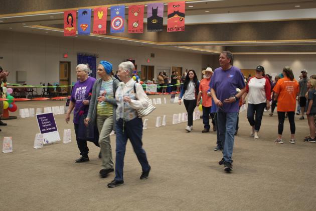 Cancer survivors and caregivers walk in the Relay.