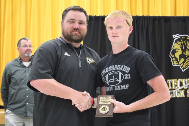 Coach Bullock presents a Senior Award.