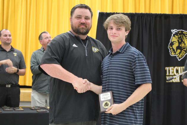 Coach Bullock presents a Senior Award.