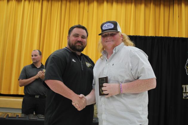 Coach Bullock presents a Senior Award.