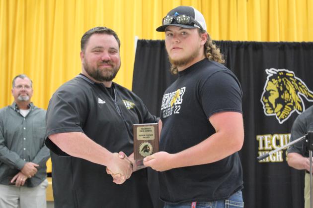 Coach Bullock presents a Senior Award.