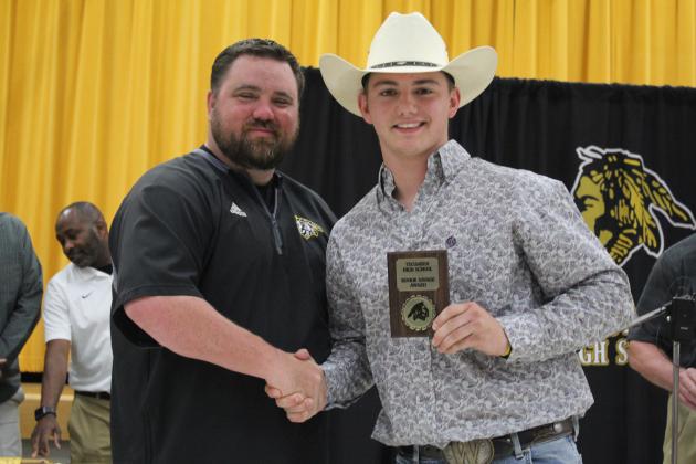 Coach Bullock presents a Senior Award.