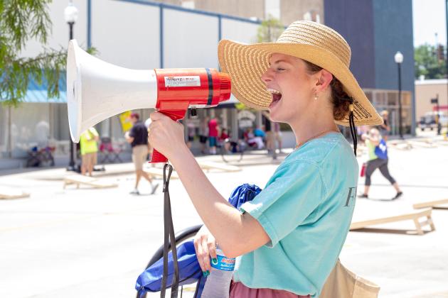Fhionna Shaughnessy cheered on participants with the megaphone during their cornhole games. Countywide &amp; Sun/Loren Knight