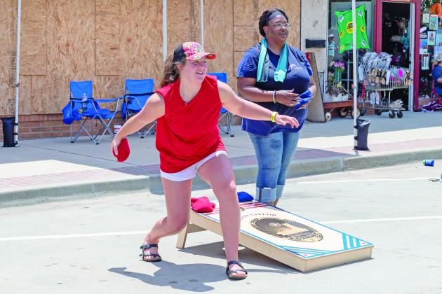 Franki Hull (left) braces for her throw while Rolanda Carr (right) stayed focused for her next turn.  Countywide &amp; Sun/Loren Knight