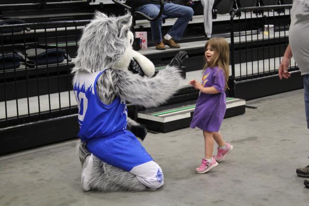 Marianne Chastain, 2, of Shawnee, gives a high five to Mo the Fire Wolf during halftime of the Potawatomi Fire's first Second-Round Playoff game against the Shreveport Mavericks at FireLake Arena on June 8.