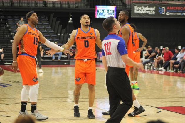 Potawatomi Fire Guard David Godbold (#15) and Forward Mustapha Traore, far right, encourage Point Guard Deshawn Munson and share in his happiness when a free throw went in during the second First-Round Playoff game against the Rockwall 7ers on June 4. The Fire won both games against the 7ers, 111-96 on June 2, and 125-83 on June 4. For their second round, they will play the Shreveport Mavericks, with the first game at FireLake Arena on June 8 and the next two games in Shreveport on June 10-11.