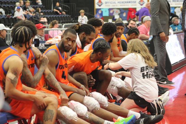 Potawatomi Fire Athletic Trainer Taylor Williams, a Tecumseh alum, applies ice to Anthony Allen's knees, after doing the same to Deon Lyle, second from left, and Mustapha Traore during the second First-Round Playoff game against the Rockwall 7ers on June 4. The Fire won both games against the 7ers, 111-96 on June 2, and 125-83 on June 4. For their second round, they will play the Shreveport Mavericks, with the first game at FireLake Arena on June 8 and the next two games in Shreveport on June 10-11.