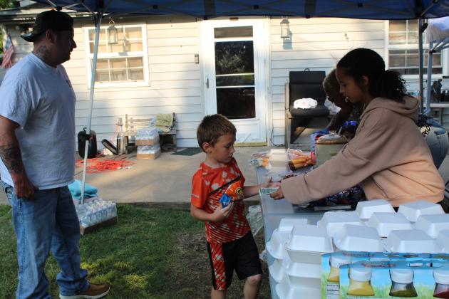 Anniah Phillips sells snacks to raise money for a neighborhood man.