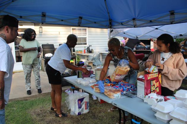 Demetria Bivens and Anniah Phillips prepare their benefit food booth.